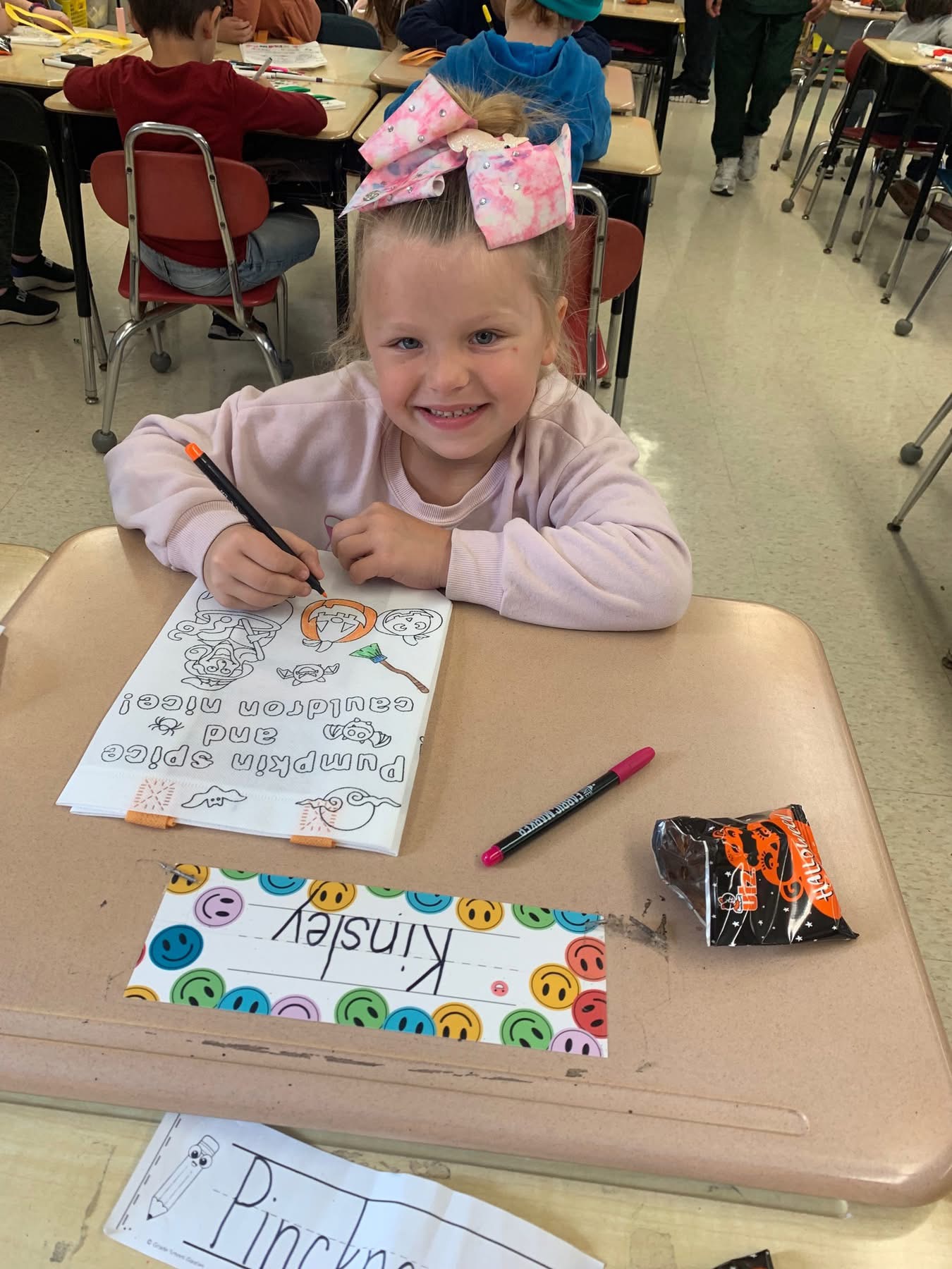 Student writing at a desk